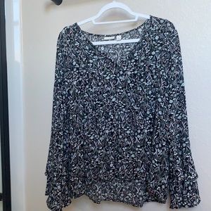 Black floral print blouse with ruffle at sleeve, high low hem